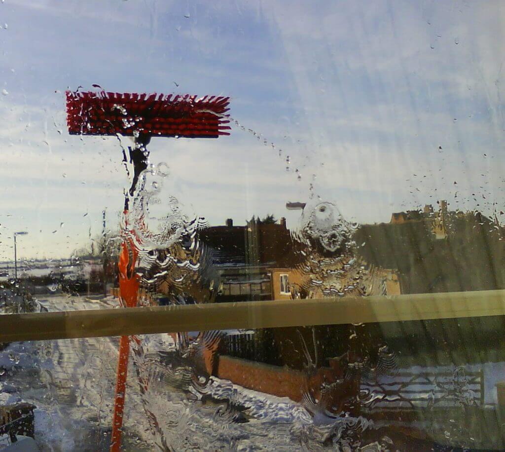 Photo of a water fed pole cleaning a second story window