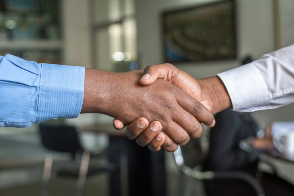 A photo of two people shaking hands to symbolize trust
