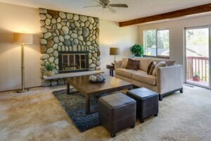 A living room with clean carpet and furniture